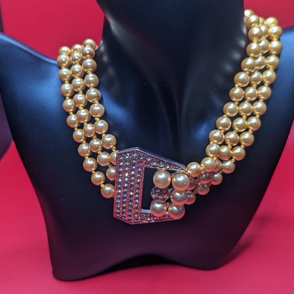 Luxurious Gold Beaded Necklace with Ornate Crystal Clasp